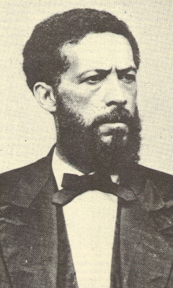John Mercer Langston, the youngest of four children, was born a free black in Louisa County, Virginia in 1829. Langston gained distinction as an abolitionist, politician, and attorney.  Despite the prominence of his slaveowner father, Ralph Quarles, Langston took his surname from his mother, Lucy Langston, an emancipated slave of Indian and black ancestry.  When both parents died of unrelated illnesses in 1834, five-year-old Langston and his older siblings were transported to Missouri where they were taken in by William Gooch, a friend of Ralph Quarles. 